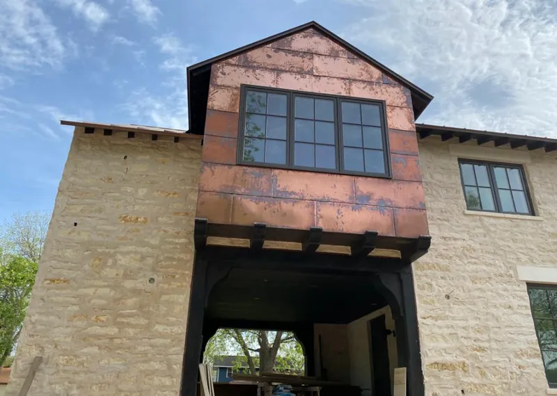 Copper metal panel facade on a stone building for Skylight Installation in Gonzalez